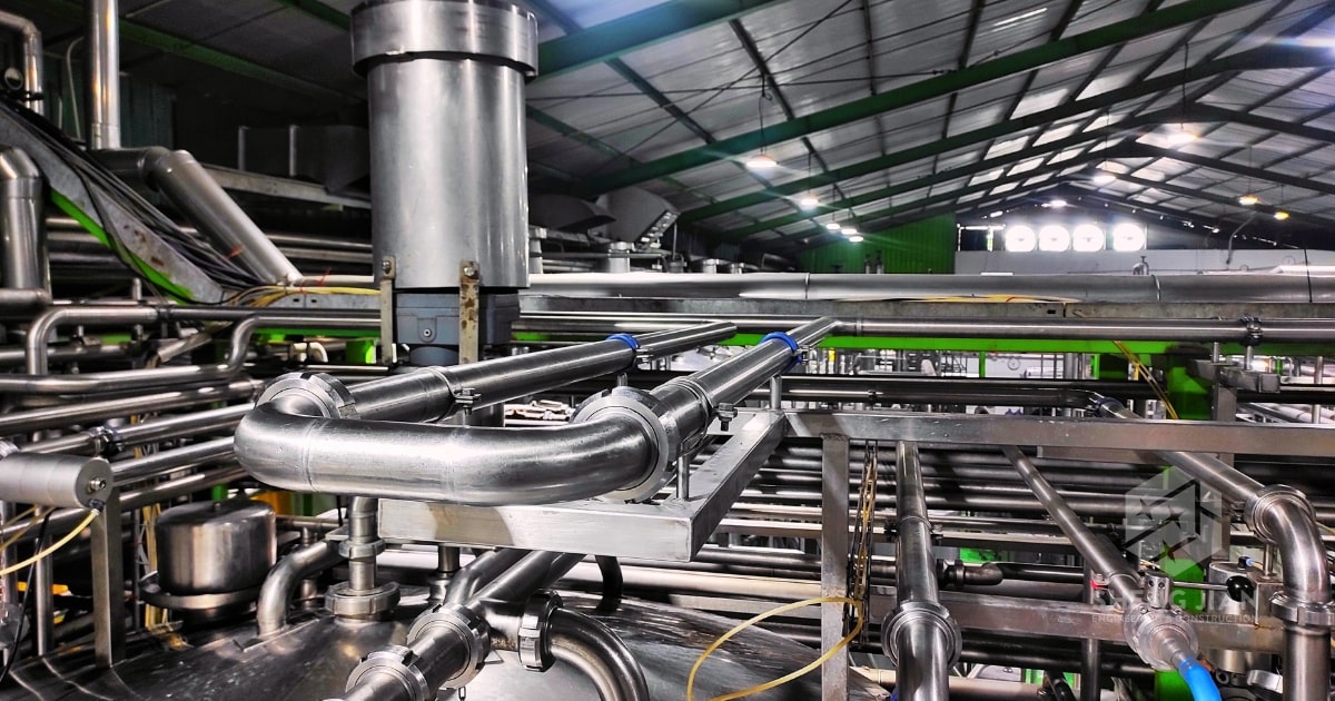 Stainless steel industrial piping in a facility.
