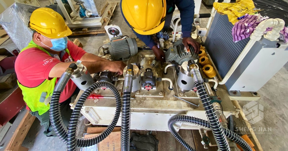 A team inspects machinery in a factory