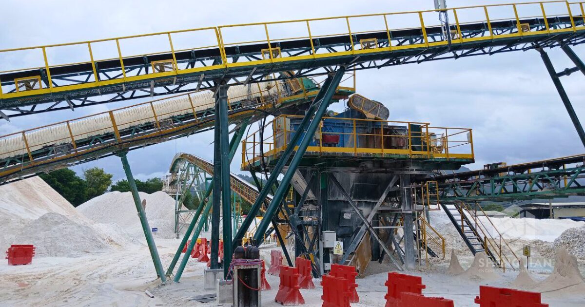 A belt conveyor system set up outdoors in an industrial setting.