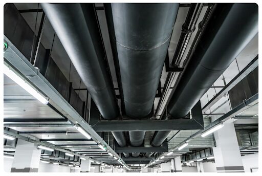 Large pipes with piping supports hanging from the ceiling.